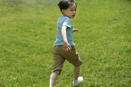 The little boy played on the grassの写真素材