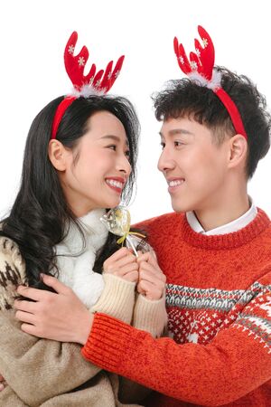 Happy young couple celebrating Christmasの写真素材