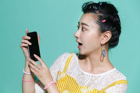 The young woman holding a mobile phoneの写真素材