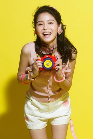 The young woman with a cameraの写真素材