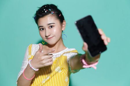 The young woman holding a mobile phoneの写真素材
