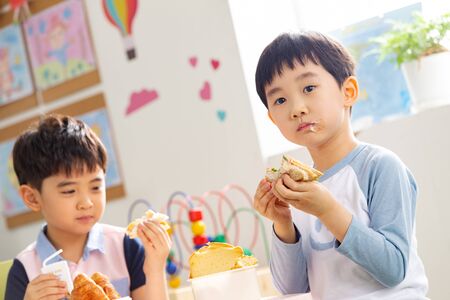 Kindergarten children eat