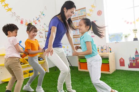 Kindergarten teachers and children are playingの写真素材