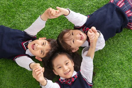 The pupils lying on the grassの写真素材