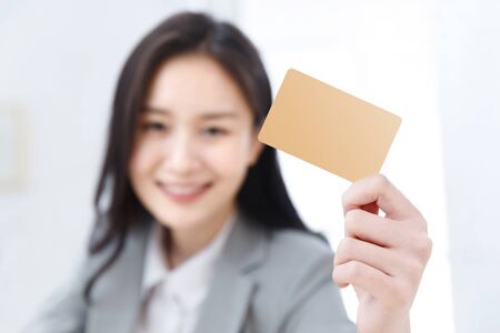 Business young woman with a cardの写真素材