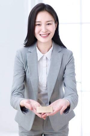 Business young woman with a cardの写真素材