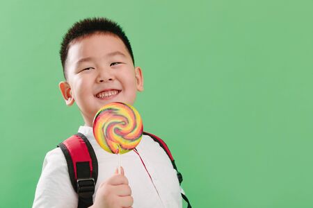 Lovely boy holding a lollipop