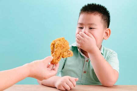 Lovely little boy looked at the Fried chickenの写真素材