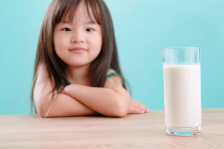 Cute girl and a glass of milkの写真素材