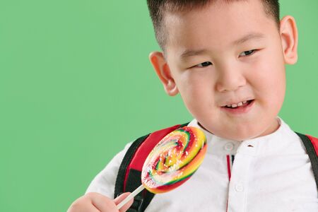 Lovely boy holding a lollipop