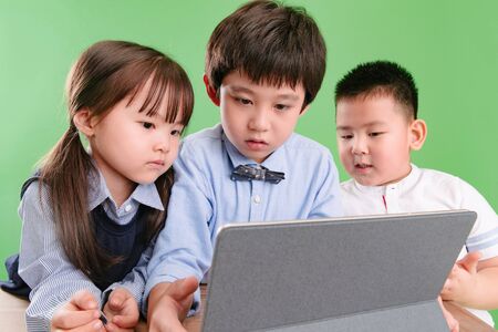 Two children use tabletの写真素材