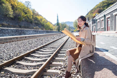 Young woman were sitting beside the tracksの写真素材