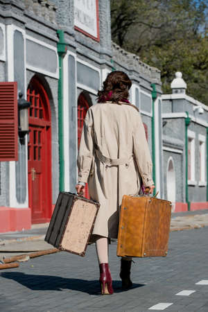 Young woman holding a travel luggage