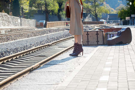 The young woman standing beside the tracksの写真素材