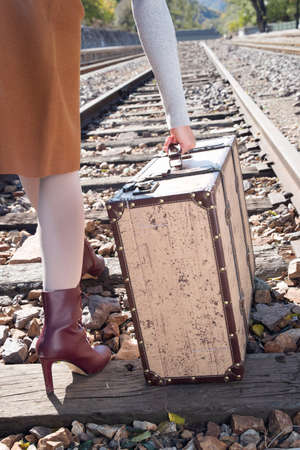 Young woman holding a travel luggageの写真素材