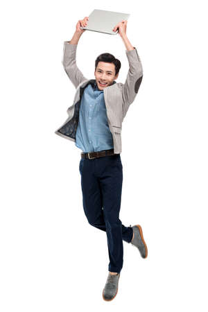 Carrying a laptop bouncing youth businessmanの写真素材