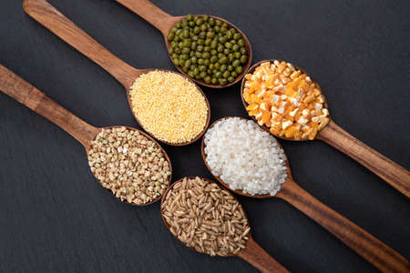 Wooden spoon is filled with grain