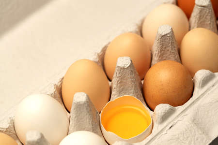 A box full of eggs and a broken egg