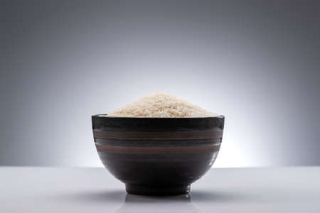 Under the background of white a bowl of riceの写真素材