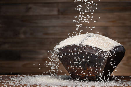 Wooden bucket full of riceの写真素材
