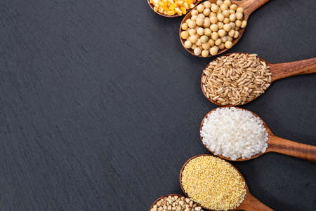 Wooden spoon is filled with grainの写真素材