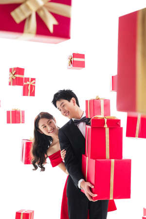 Happy young couples holding the gift boxの写真素材