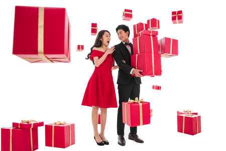 Happy young couples holding the gift boxの写真素材