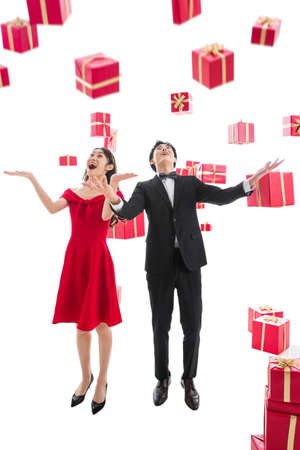 Stretch hand to pick up a gift of happy couplesの写真素材
