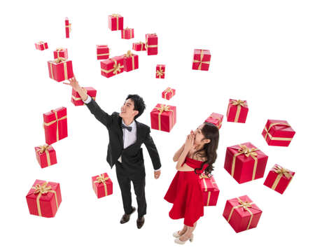 Stretch hand to pick up a gift of happy couplesの写真素材