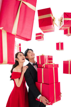 Happy young couples holding the gift boxの写真素材