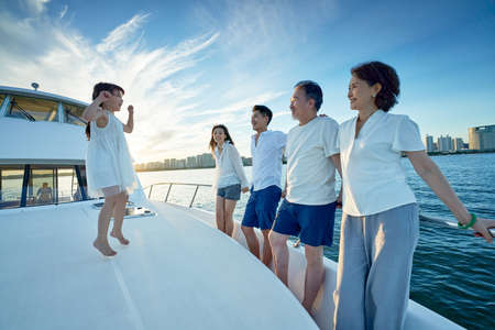 Happy family aboard a yacht out to sea