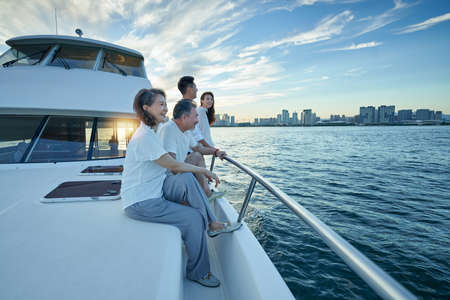 Happy family aboard a yacht out to seaの写真素材