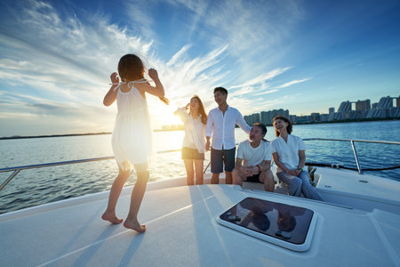 Happy family aboard a yacht out to seaの写真素材