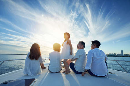 Happy family aboard a yacht out to sea