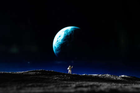 Astronaut standing on moon surface. Space travel concept. 3D Rendering