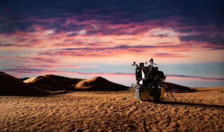 Miniature model of a satellite in the desert at sunset. 3d rendering.の写真素材