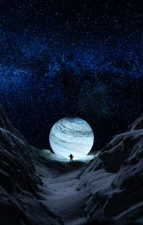 Man standing on the edge of a snowy mountainの写真素材