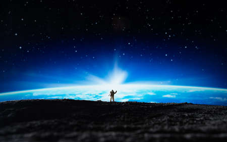 Miniature people : Astronaut standing on the moon and looking to space.の写真素材