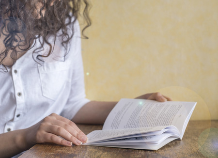 The girl is reading a book in sunny dayの写真素材