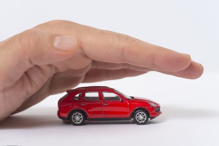 Car (automobile) insurance and collision damage waiver concepts. Businessman with protective gestureの写真素材