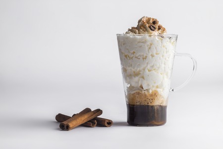 Cold fresh ice coffee with cinnamon in white backgroundの写真素材