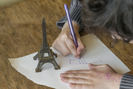 The child is drawing with penの写真素材