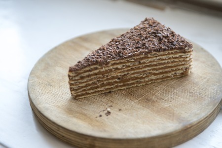 delicious chocolate cake on a wooden standの写真素材
