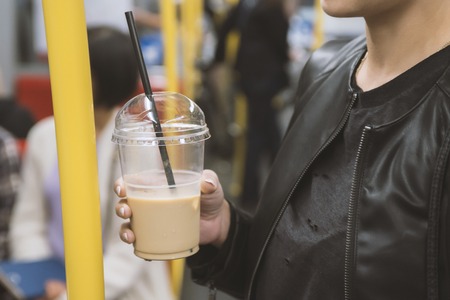 Take away cup with cappuccino in womanâs handの写真素材