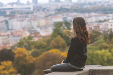Woman enjoying the view of the city on an autumn dayの写真素材