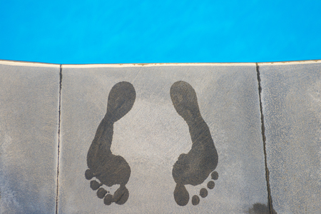 wet footprints on stone near the poolの写真素材