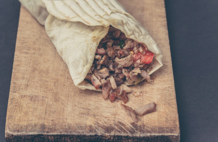Doner kebab is on the cutting board.