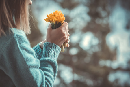 Woman hold bouquet of yellow flowers