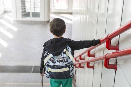 a child with a backpack on his back goes to schoolの写真素材