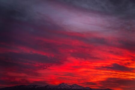 Natural sunset sunrise. Bright dramatic sky and dark earth.の写真素材